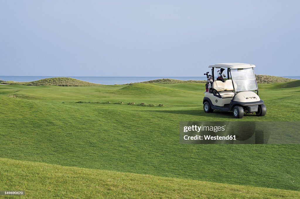 Turkey, Antalya, Golf cart on meadow at golf course