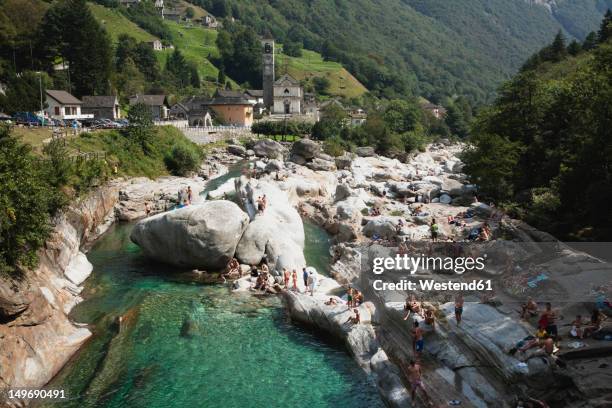 switzerland, people bathing at verzasca river - valle verzasca stock-fotos und bilder