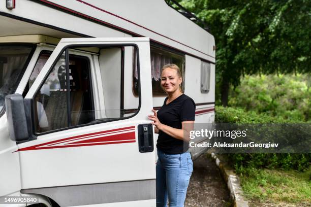 portrait of cute blond female and her rv motorhome in nature - motor home stock pictures, royalty-free photos & images