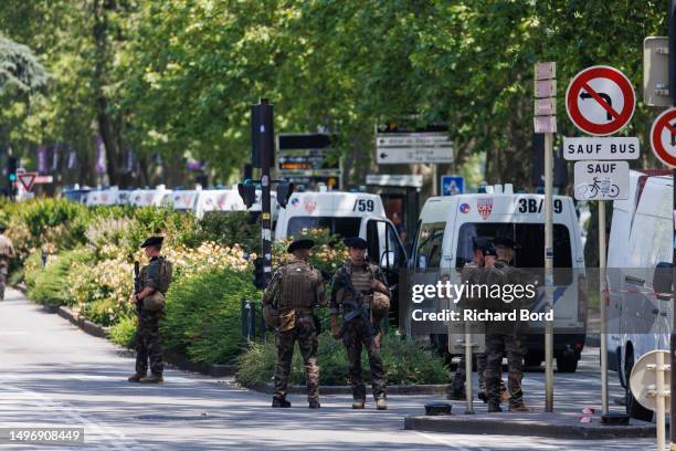 Law enforcement stand near Paquier park where a man stabbed multiple people on June 8, 2023 in Annecy, France. Four children were among the victims...