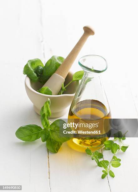 basil and oregano leaf in mortar and pestle - orégano fotografías e imágenes de stock