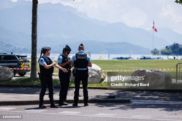 Law enforcement stand near Paquier park where a man stabbed multiple people on June 8, 2023 in Annecy, France. Four children were among the victims...