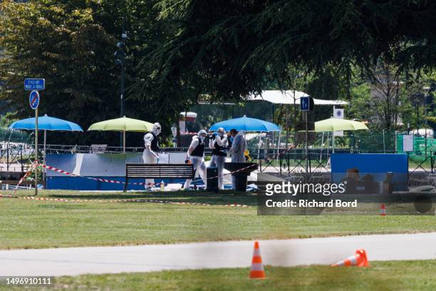 Scientific police works on the crime scene in the Paquier park where a man stabbed multiple people on June 8, 2023 in Annecy, France. Four children...