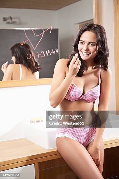 germany, bavaria, young woman in bathroom, lipstick message on mirror - telephone number stock pictures, royalty-free photos & images