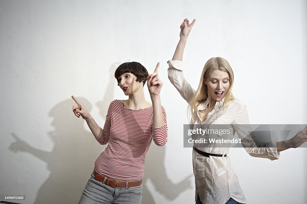 Germany, Cologne, Young women having fun, smiling