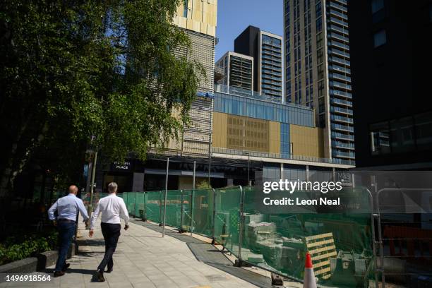 Two men walk near to the Victoria Place retail and residential complex on June 08, 2023 in Woking, England. Woking Borough Council issued a section...