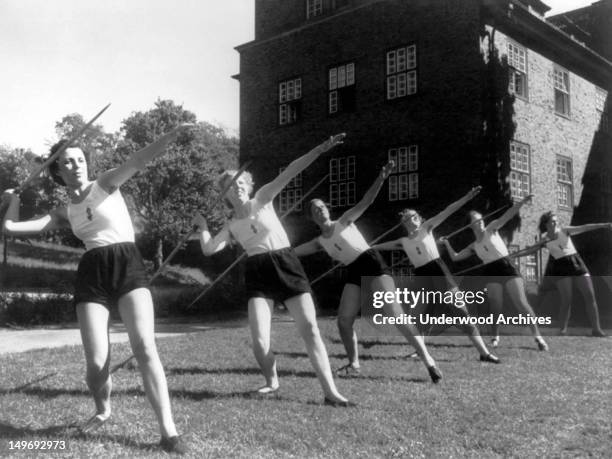 Line of six young woman throwing javelins, Germany, early 1940s. They are members of the 'NSV,' the welfare organization of the Nazi party in Germany...