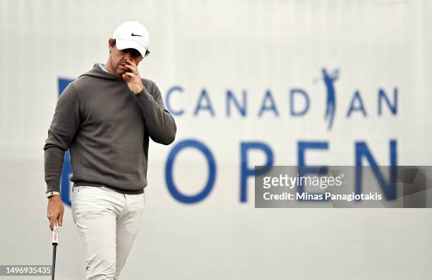 Rory McIlroy of Northern Ireland reacts after making his putt on the 1st hole during the first round of the RBC Canadian Open at Oakdale Golf &...
