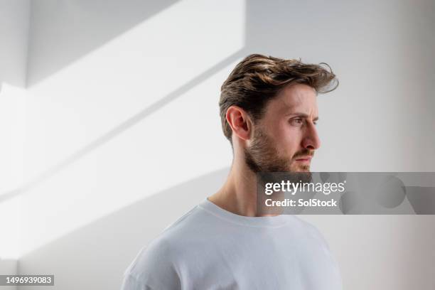 standing in the sunlight - man portrait stock pictures, royalty-free photos & images