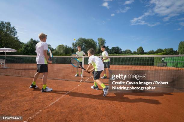 young boys playing tennis, bavaria, germany - doubles sports stock pictures, royalty-free photos & images