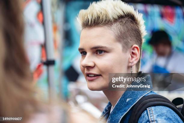 candid portrait of young londoner with half-shaved hairstyle - brick lane inner london stock pictures, royalty-free photos & images