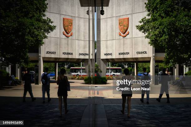 The Woking Borough Council offices are reflected in the window of the library on June 08, 2023 in Woking, England. Woking Borough Council issued a...
