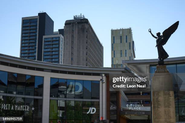 An angel on the top of the war memorial looks towards the Victoria Place retail and residential complex on June 08, 2023 in Woking, England. Woking...