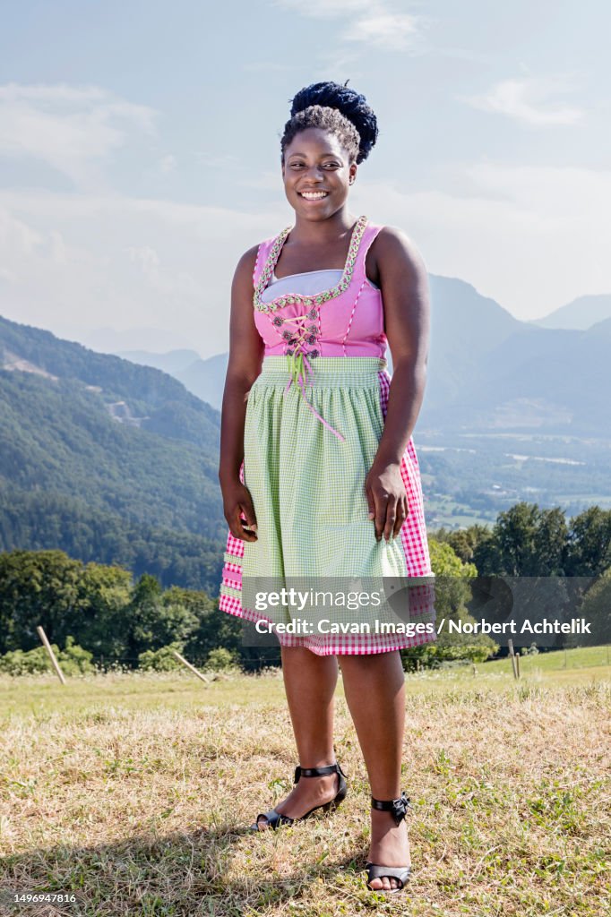 Teenage girl posing outdoors in traditional dress dirndl, Bavaria, Germany