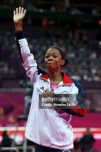 Gabrielle Douglas of the United States waves to the crowd after Douglas wins the gold medal in the Artistic Gymnastics Women's Individual All-Around...