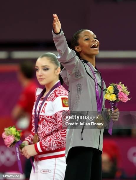 Gabrielle Douglas of the United States celebrates on the podium after winning the gold medal in the Artistic Gymnastics Women's Individual All-Around...