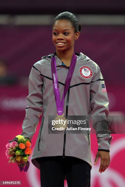 Gabrielle Douglas of the United States celebrates on the podium after winning the gold medal in the Artistic Gymnastics Women's Individual All-Around...