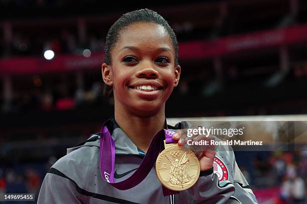 Gabrielle Douglas of the United States celebrates on the podium after winning the gold medal in the Artistic Gymnastics Women's Individual All-Around...