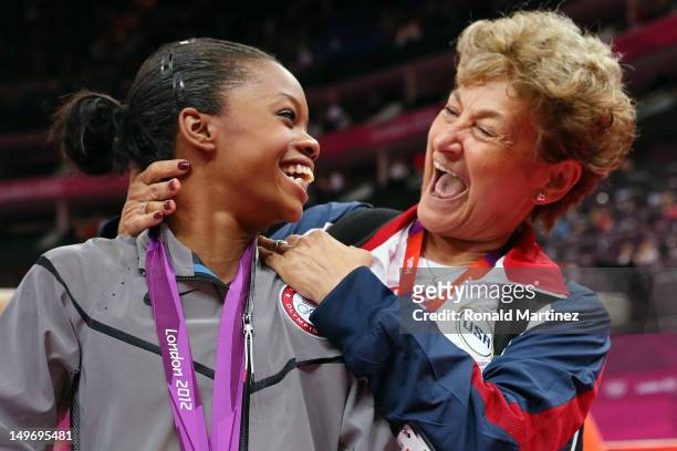 Gabrielle Douglas of the United States celebrates winning the gold medal with team coordinator Martha Karolyi after the Artistic Gymnastics Women's...