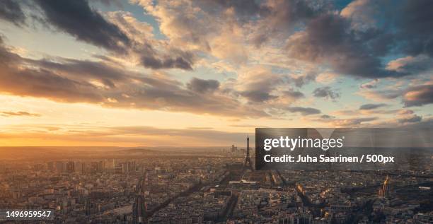 aerial view of city against cloudy sky during sunset,paris,france - paris france stock pictures, royalty-free photos & images