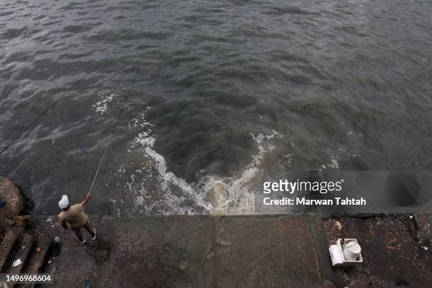 Citizens fishing in an area polluted by waste water on June 8, 2023 in Beirut, Lebanon. With some 225 km of coastline harbouring Lebanon's major...
