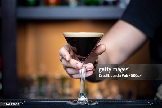 midsection of woman holding glass,iceland - espresso martini stock pictures, royalty-free photos & images