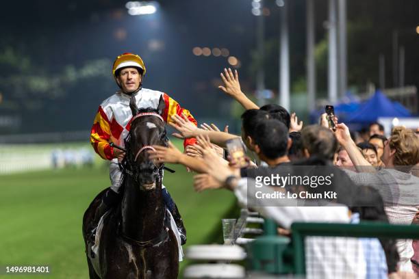 Jockey Hugh Bowman gives out a high five after Solar Partner winning the Race 6 Kwai Fong Handicap at Happy Valley Racecourse on May 31, 2023 in Hong...