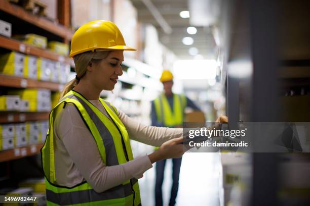 female warehouse worker scanning boxes with bar code scanner - rfid stock pictures, royalty-free photos & images