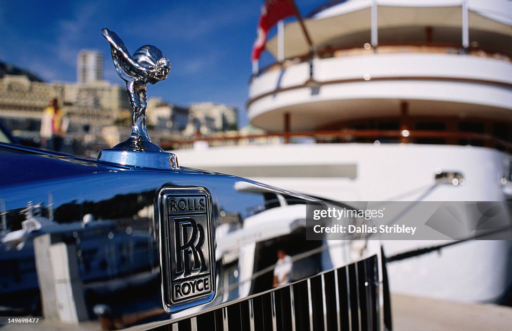 Detail of Rolls Royce parked in front of luxury yacht, Port Hercule.