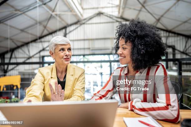 businesswomen talking on a meeting at office - feedback business stock pictures, royalty-free photos & images