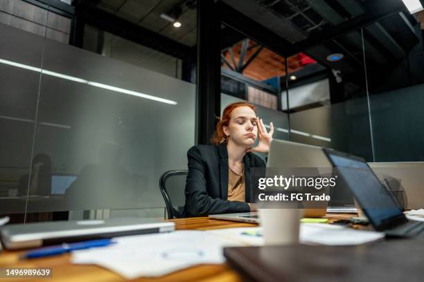 tired businesswoman working using laptop at office - network failure stock pictures, royalty-free photos & images