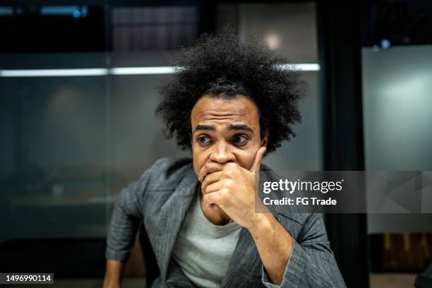 worried businessman with hand on mouth at office - hålla handen för munnen bildbanksfoton och bilder