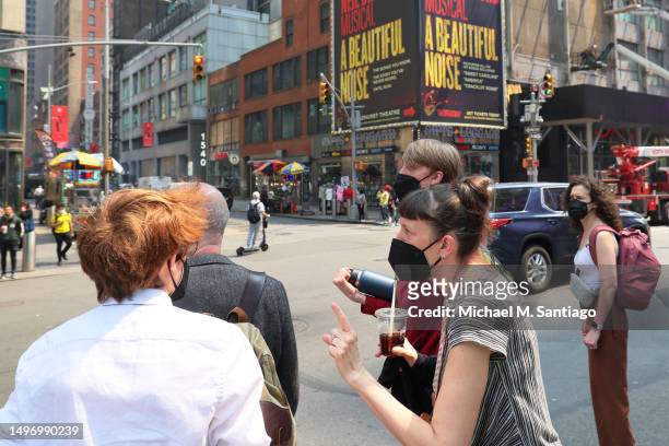 People wear masks amid hazy conditions due to smoke from the Canadian wildfires in Times Square on June 08, 2023 in New York City. People in the city...