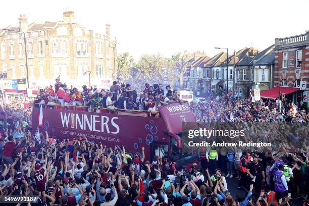 General view as players of West Ham United pass through a crowd of fans on an Open-Top Bus during the West Ham United trophy parade on June 08, 2023...