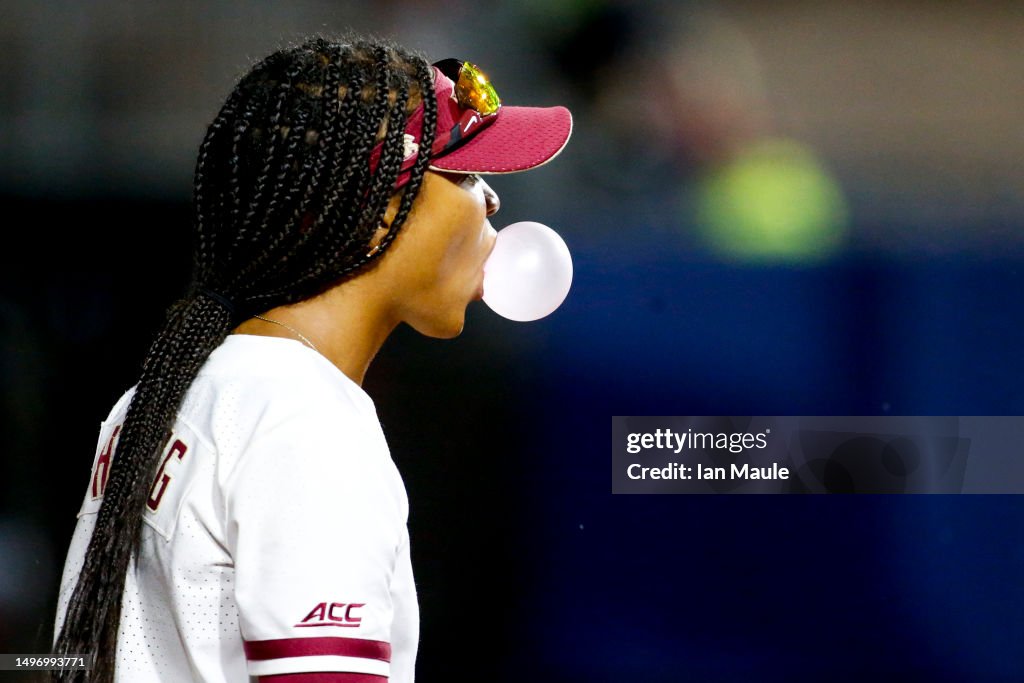 Kalie Harding Kalei Harding of the Florida State Seminoles blows a bubble while ...
