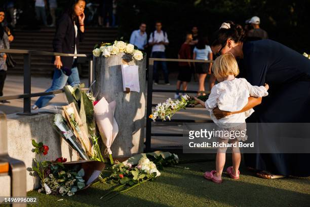 Woman and her daughter lay flowers at the children's park in Paquier park, where a knife attack took place, on June 8, 2023 in Annecy, France....