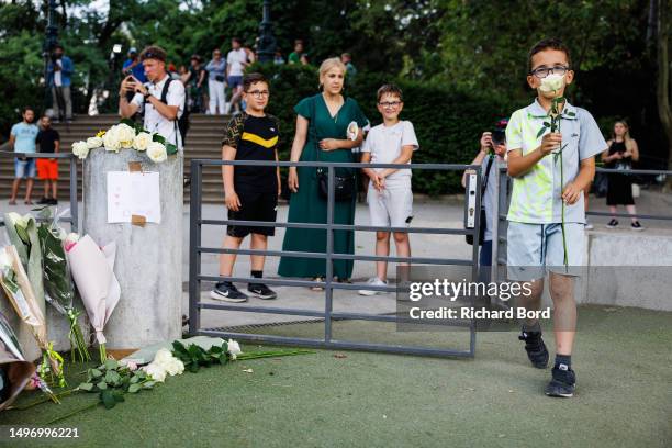 Boy lays flowers at the children's park in Paquier park, where a knife attack took place, on June 8, 2023 in Annecy, France. Several people,...
