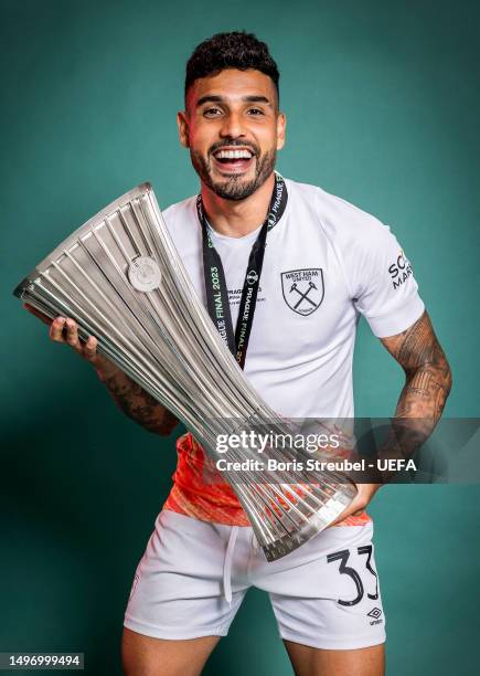 Emerson Palmieri of West Ham United poses for a photograph with the UEFA Europa Conference League trophy after the UEFA Europa Conference League...