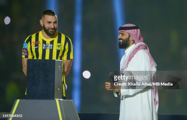 Karim Benzema speaks with Anmar Al-Haili, President of Al-Ittihad, as being presented to the fans during the Karim Benzema Official Reception event...