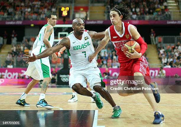 Alexey Shved of Russia drives on Larry Taylor of Brazil in the second half during the Men's Basketball Preliminary Round match on Day 6 of the London...
