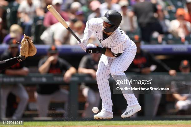 Randal Grichuk of the Colorado Rockies is hit by a pitch against the San Francisco Giants in the first inning at Coors Field on June 08, 2023 in...