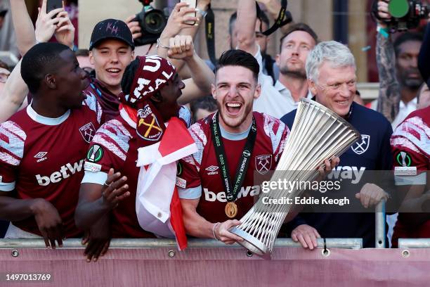 Declan Rice of West Ham United celebrates with teammateswith the Europa Conference League trophy as players of West Ham United celebrate on a balcony...