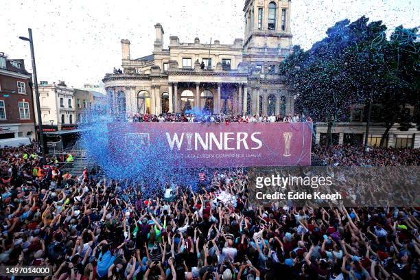 General view as players of West Ham United celebrate with the Europa Conference League trophy on a balcony whilst looking out over a crowd of fans...