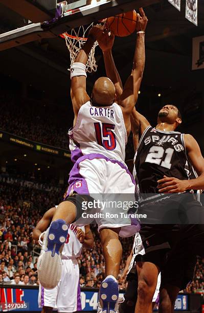Vince Carter of the Toronto Raptors is stopped in mid air by Tim Duncan of the San Antonio Spurs at Air Canada Centre in Toronto, Canada. DIGITAL...