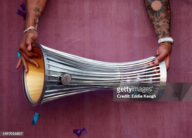 Detailed view of the Europa Conference League trophy in the hands of Alphonse Areola of West Ham United as they present it to fans, as players of...