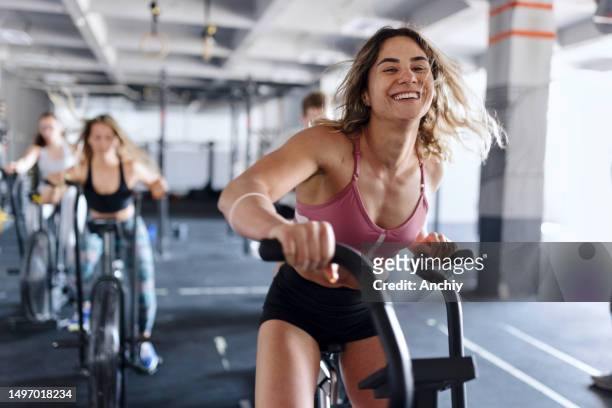 strong and healthy people working out - cycling gym stock pictures, royalty-free photos & images