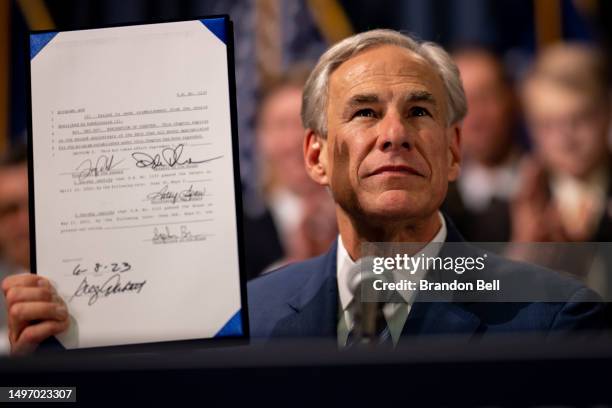 Texas Gov. Greg Abbott displays a bill he signed at a news conference at the state Capitol on June 08, 2023 in Austin, Texas. Abbott and Texas...