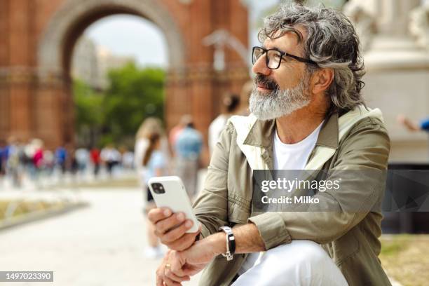 smiling good looking senior man on the street - masculinidade moderna imagens e fotografias de stock
