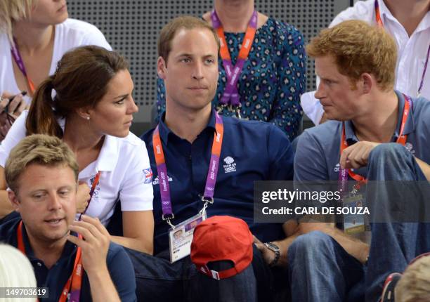 Great Britain's Prince Williams , his wife Kate Middleton and his brother Prince Harry speak together as they attend the Men's team sprint track...