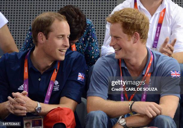 Great Britain's Prince Harry speaks with his brother Prince Williams as they attend the Men's team sprint track cycling event of London 2012 Olympic...